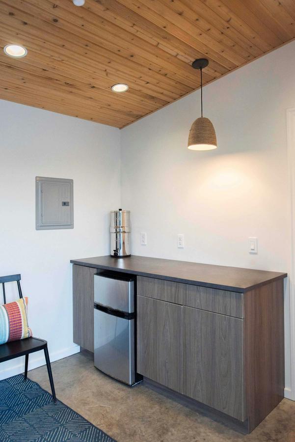 Inside the pool house: counter, mini fridge and pendant light